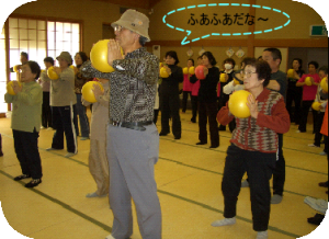 「小ボール体操」の様子。和室で小ボールを両手で挟んで「ふあふあだな～」の画像